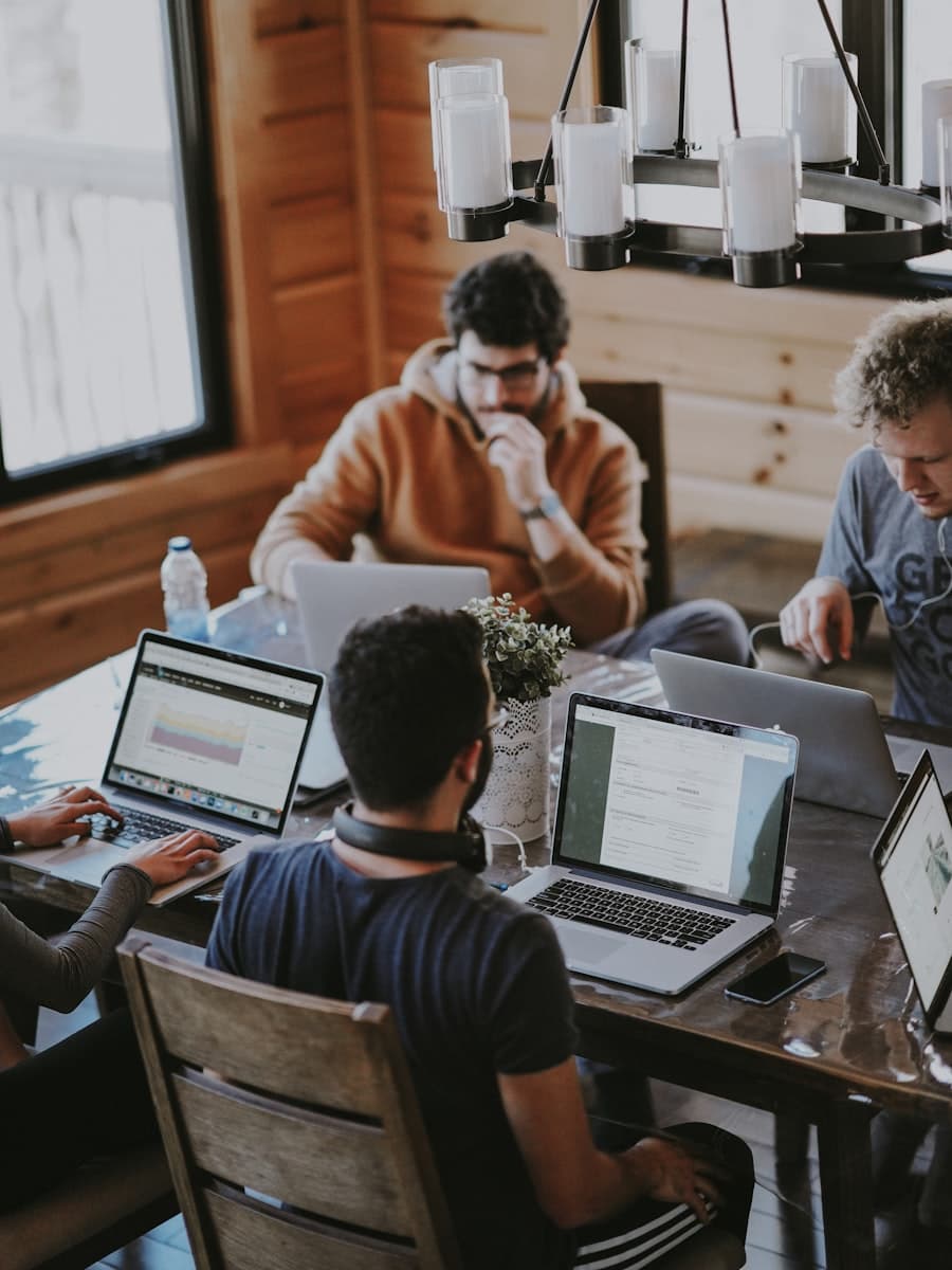 A small founding team working on laptops around one table