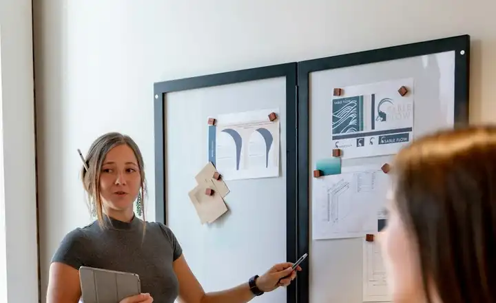 A strategist presenting a campaign board to her team